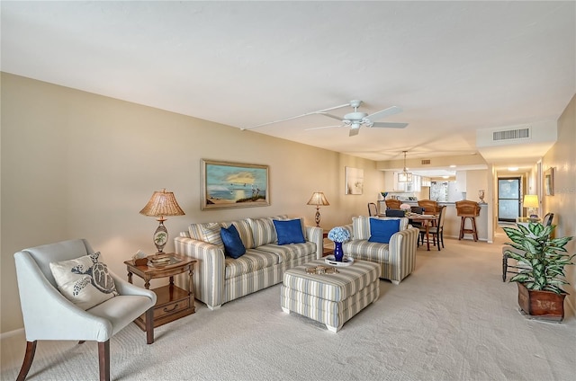 living room with light colored carpet and ceiling fan