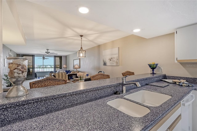 kitchen with white cabinetry, sink, ceiling fan, white dishwasher, and pendant lighting