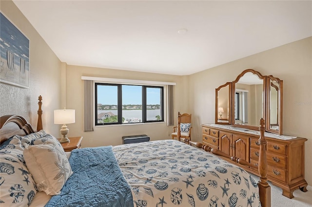 carpeted bedroom with a water view