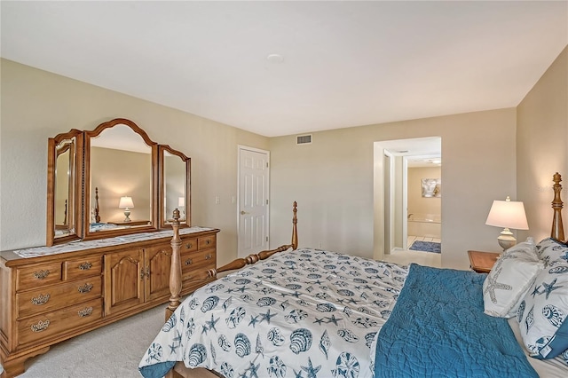 carpeted bedroom with ensuite bath and a closet