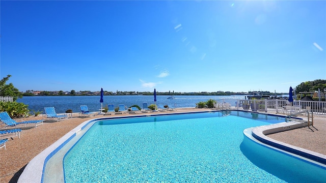 view of pool featuring a patio area and a water view