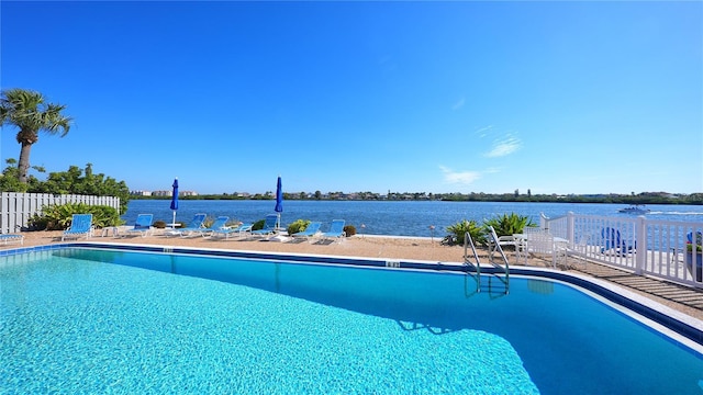 view of swimming pool featuring a water view