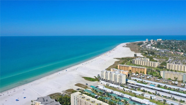 bird's eye view featuring a water view and a beach view