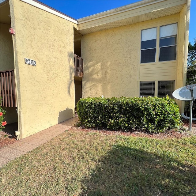 view of side of property with a lawn