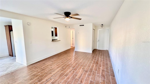 spare room with hardwood / wood-style floors and ceiling fan