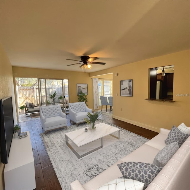 living room with dark hardwood / wood-style floors and ceiling fan