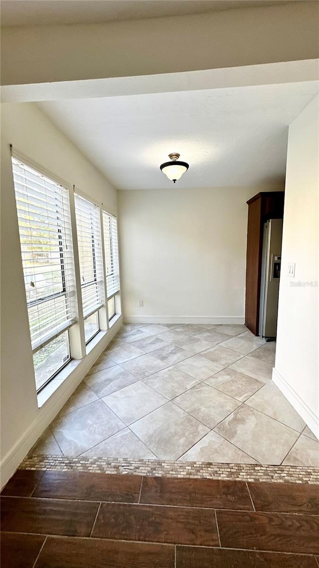 spare room featuring light tile patterned floors