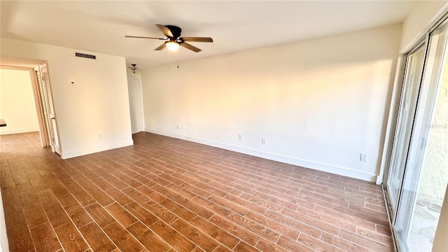 empty room with dark hardwood / wood-style floors and ceiling fan