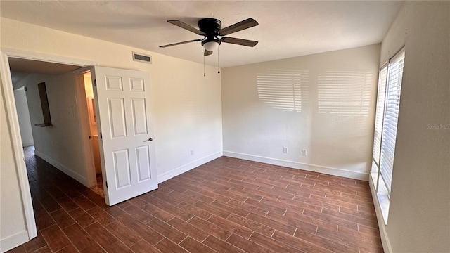 empty room featuring dark hardwood / wood-style floors and ceiling fan