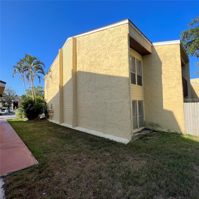 view of side of home featuring a lawn