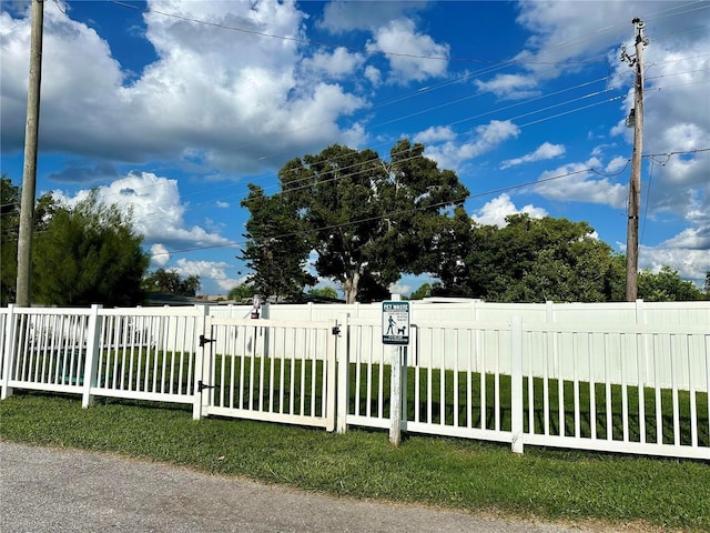 view of gate featuring a lawn