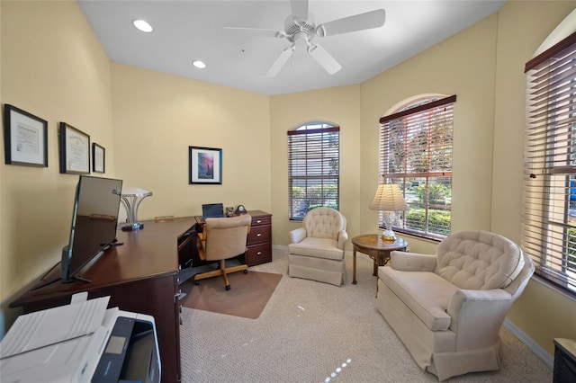 carpeted office with ceiling fan and plenty of natural light