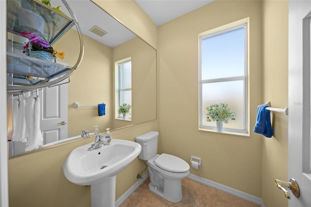 bathroom featuring tile patterned flooring, sink, and toilet