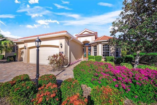 mediterranean / spanish-style house with a garage