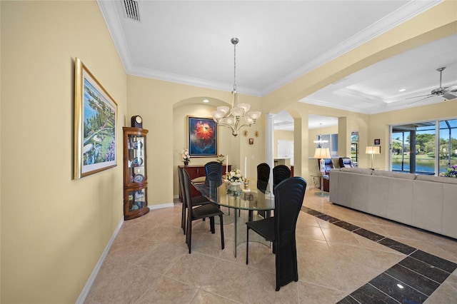 tiled dining room featuring ornamental molding, a tray ceiling, and ceiling fan with notable chandelier