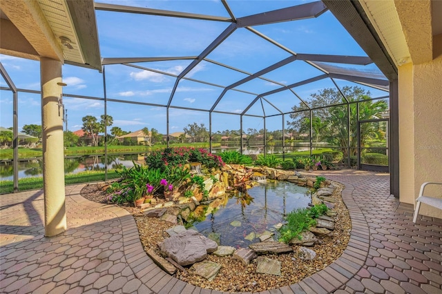 view of patio / terrace with a water view and glass enclosure