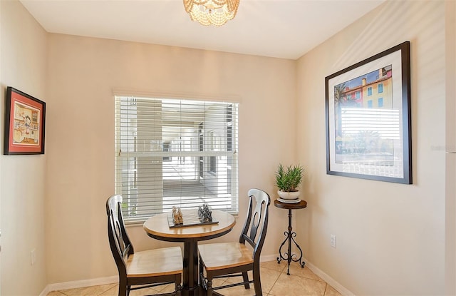 tiled dining area featuring an inviting chandelier