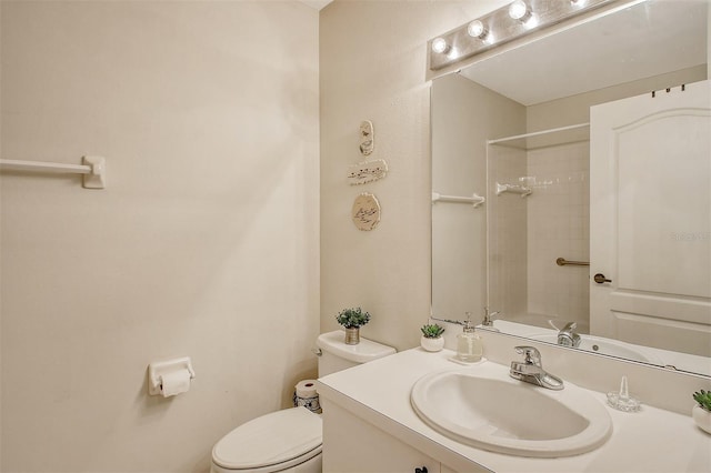 full bathroom featuring vanity, tiled shower / bath combo, and toilet