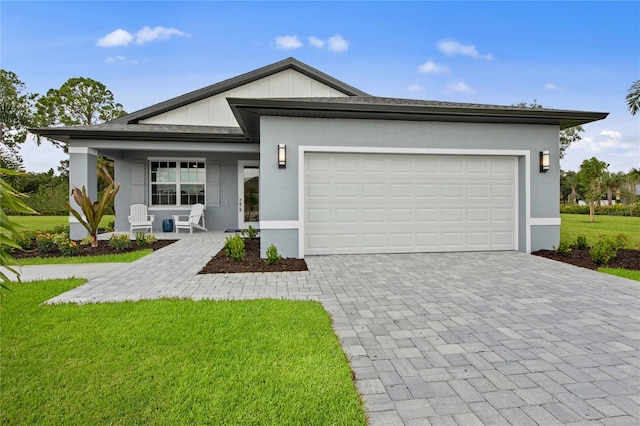 view of front of home featuring a garage and a front lawn