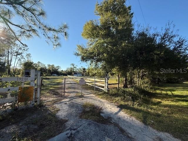 view of gate with a rural view