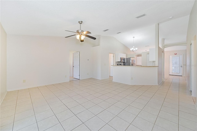 unfurnished living room featuring light tile patterned floors, ceiling fan with notable chandelier, and vaulted ceiling