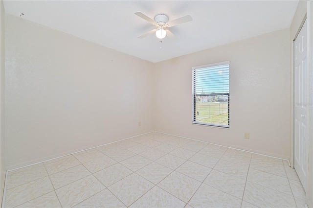 tiled empty room with ceiling fan