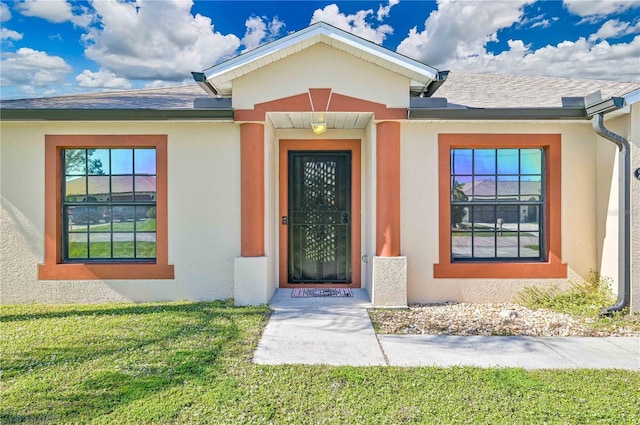 property entrance with a yard