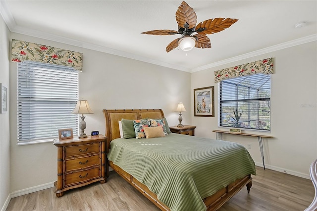 bedroom with light hardwood / wood-style floors, ceiling fan, and ornamental molding