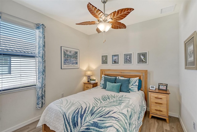 bedroom with ceiling fan and light hardwood / wood-style floors