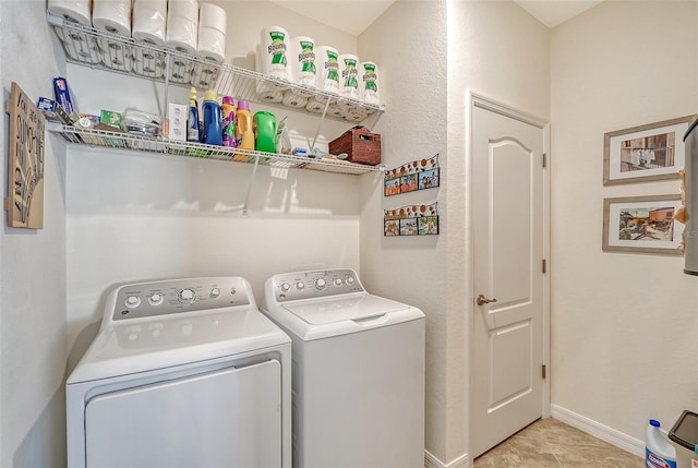 clothes washing area with laundry area, independent washer and dryer, and baseboards