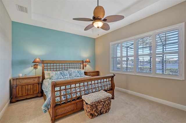 bedroom with ceiling fan and light carpet