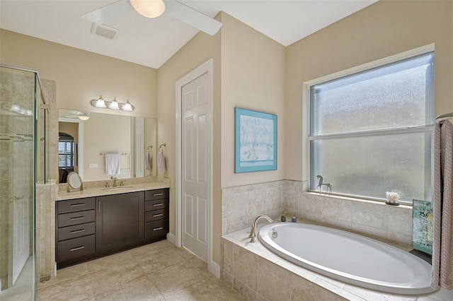 bathroom featuring tile patterned flooring, vanity, and plus walk in shower