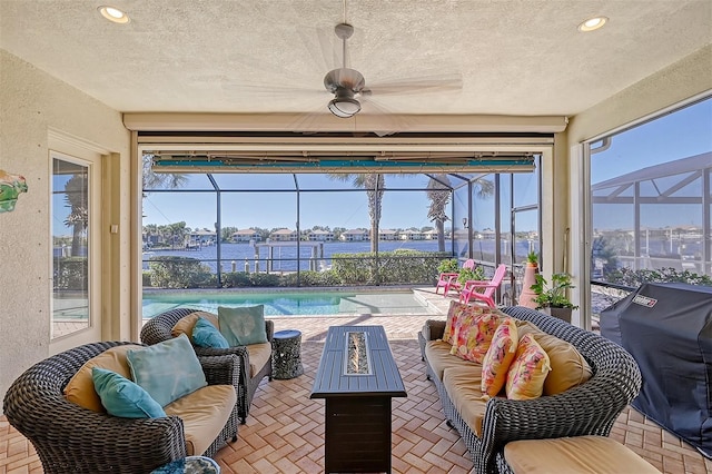 1014 Overlook Ct, Bradenton, FL 34208 - sunroom / solarium featuring an outdoor living space with a fire pit, a water view, and ceiling fan