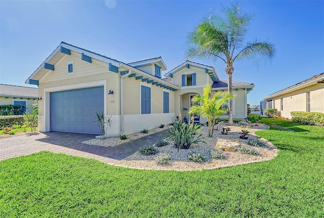 1014 Overlook Ct, Bradenton, FL 34208 - view of front of property featuring an attached garage, decorative driveway, a front yard, and stucco siding