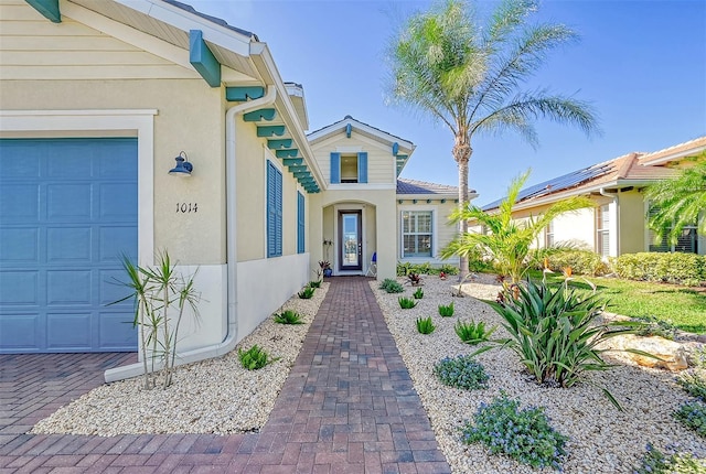 view of exterior entry featuring a garage