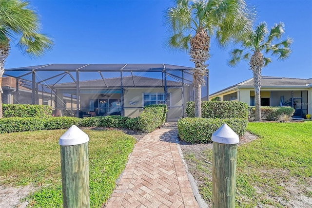 view of front facade with a lanai and a front lawn