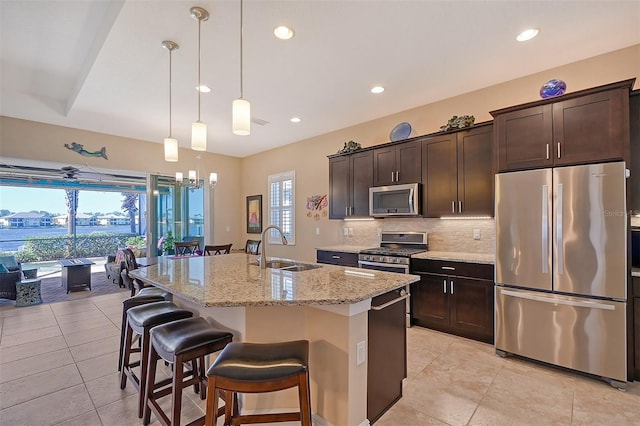 1014 Overlook Ct, Bradenton, FL 34208 - kitchen with stainless steel appliances, light tile patterned flooring, tasteful backsplash, dark brown cabinetry, and recessed lighting