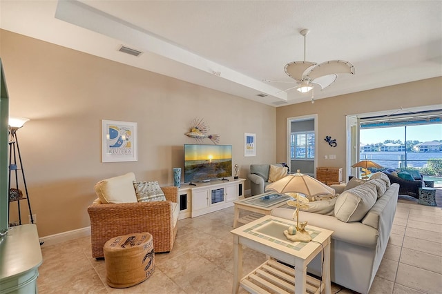 tiled living room featuring ceiling fan