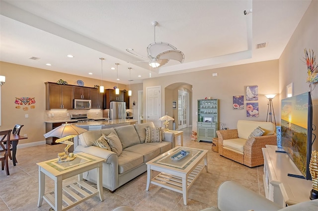 living room with ceiling fan and light tile patterned flooring