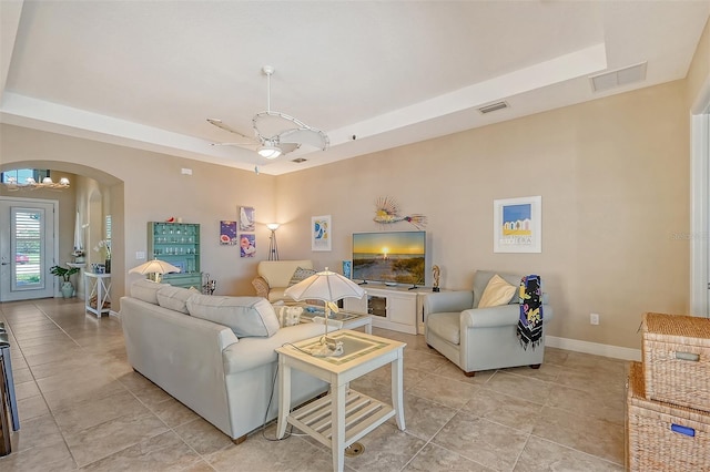 tiled living room featuring ceiling fan