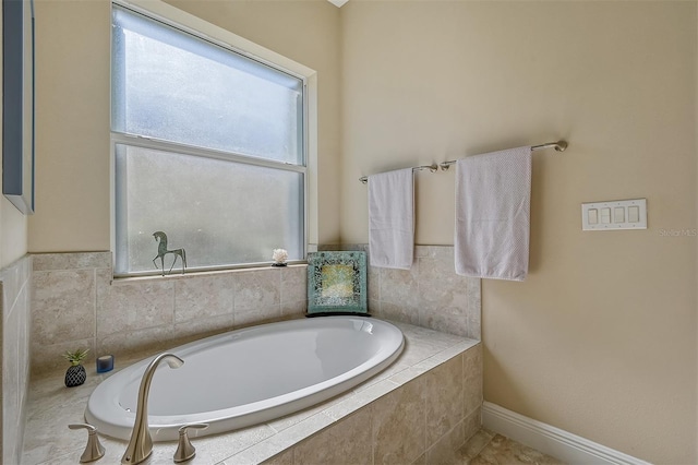 bathroom featuring tiled tub