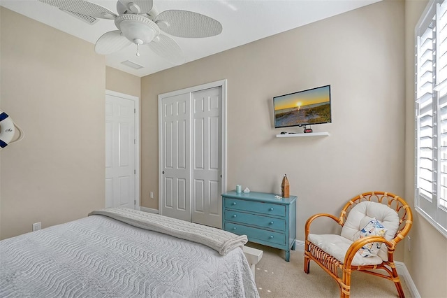 carpeted bedroom featuring ceiling fan and a closet