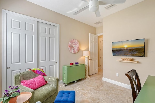 interior space with ceiling fan and light tile patterned floors