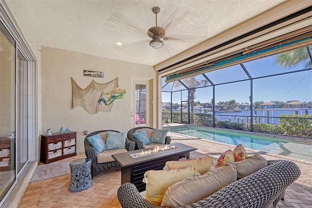 interior space with ceiling fan, a lanai, an outdoor hangout area, and a water view