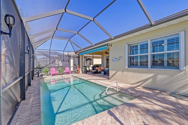 view of swimming pool with a patio, ceiling fan, and a lanai