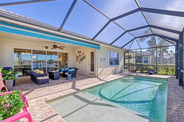 view of pool with a patio area, an outdoor living space, ceiling fan, and glass enclosure