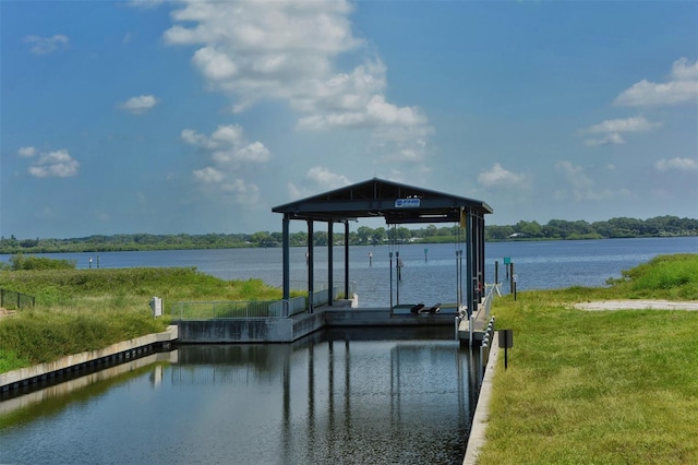 view of dock featuring a lawn and a water view