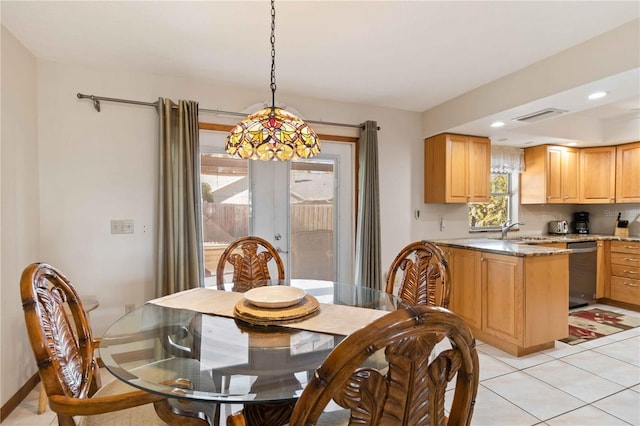 tiled dining area featuring french doors and sink