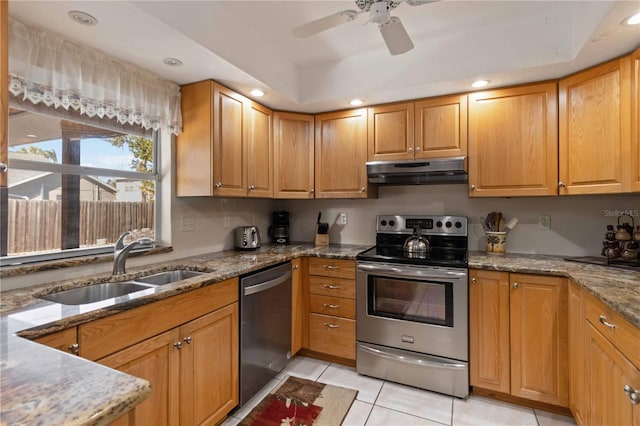 kitchen featuring sink, ceiling fan, light stone countertops, light tile patterned flooring, and stainless steel appliances