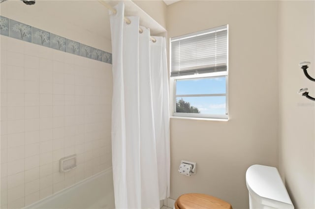 bathroom with toilet and shower / bathtub combination with curtain